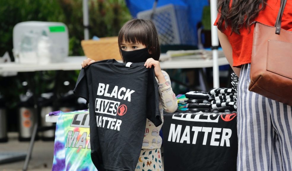 Black lives matter child holding t-shirt