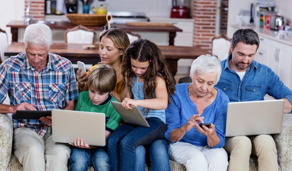 Family on laptops, tablets and mobile phones