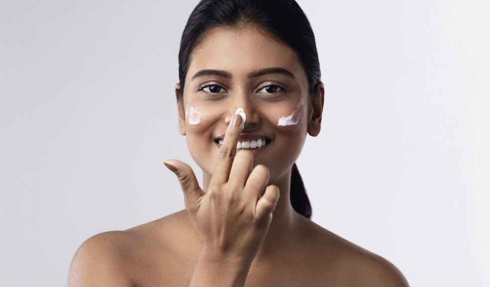 Lady applying sun cream