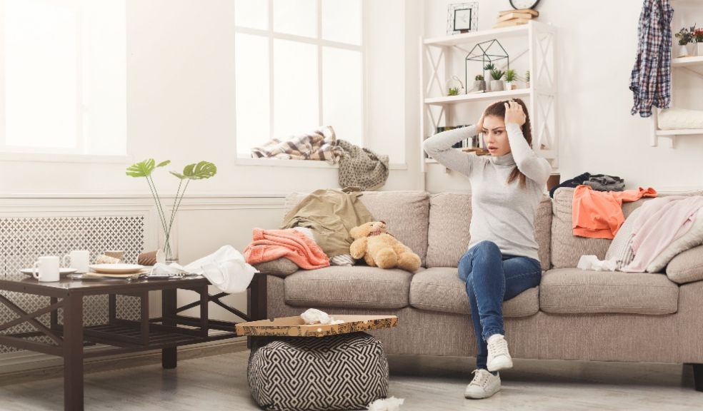 Lady at home with hands on her head