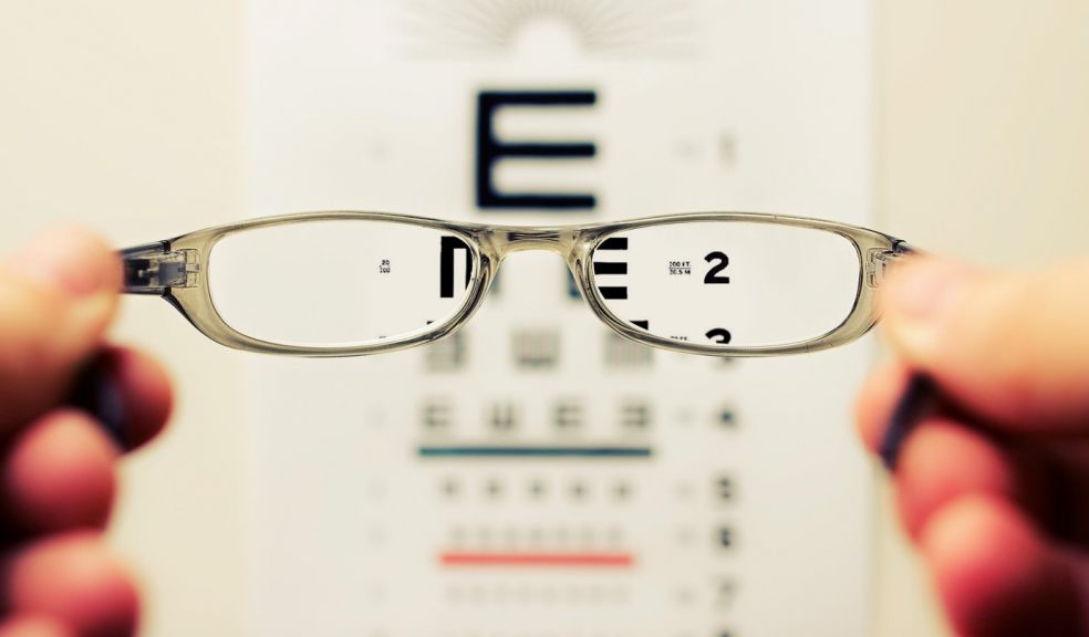 Glasses in front of an eye test chart