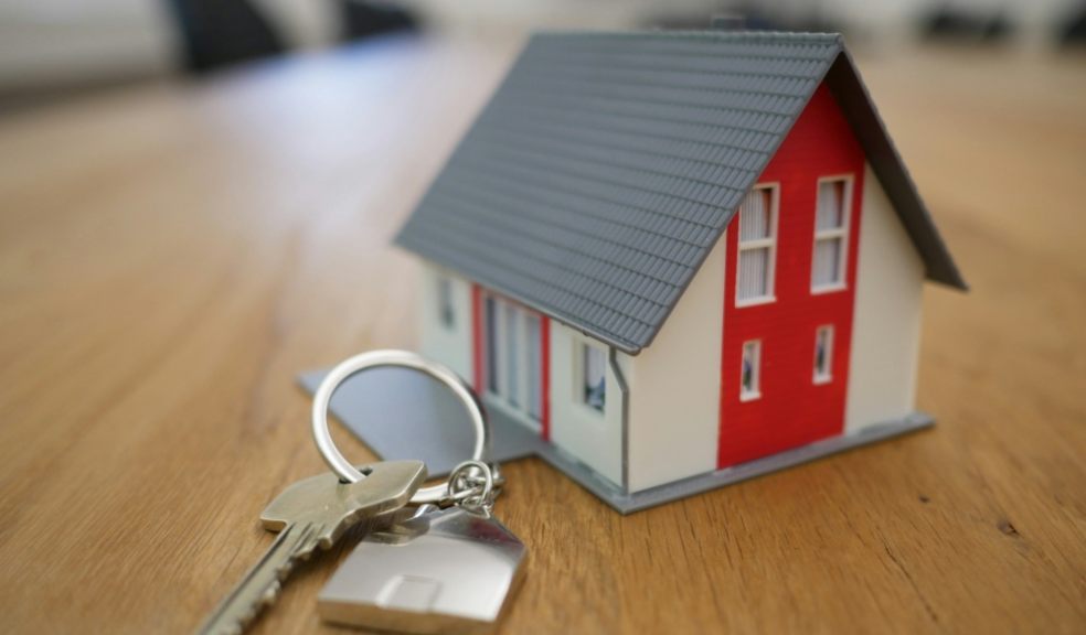 Many homebuyers report being catfished A model of a house with a key
