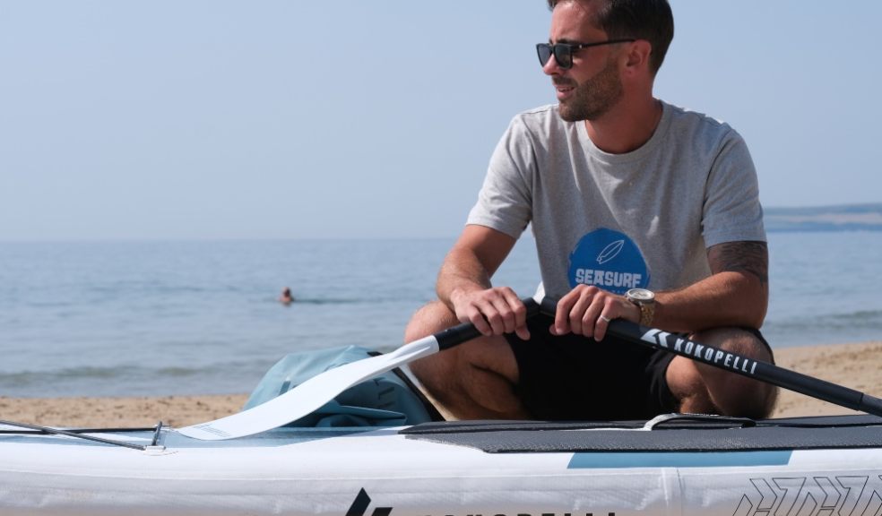 Paddleboarder with his board and oars