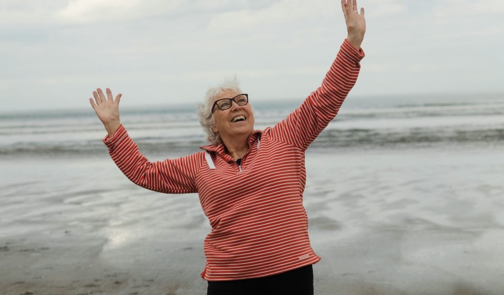 Woman on beach looking happy and free