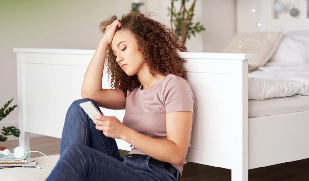 Teenager at home on phone