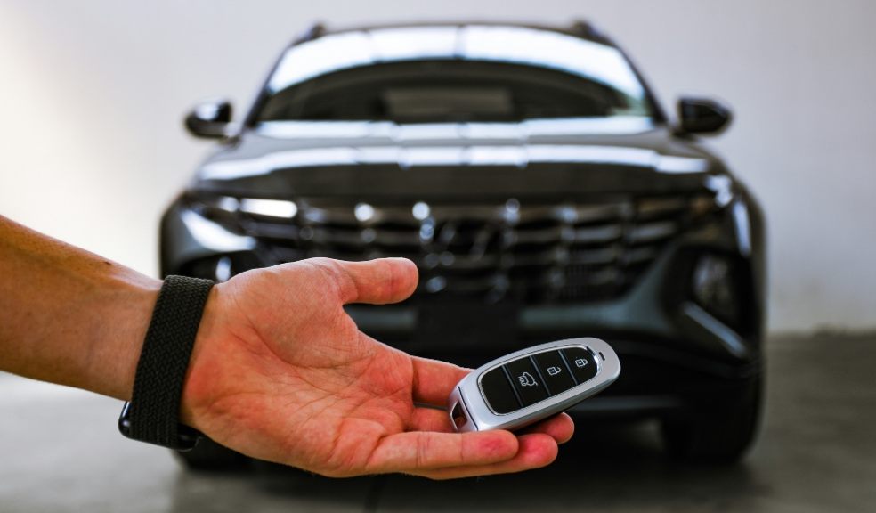There are many factors to consider when buying a new car A man holding a key in front of a new car