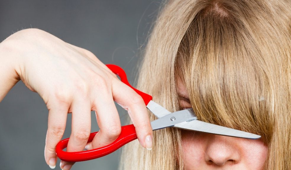 Woman cutting her fringe