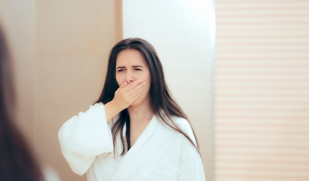 Woman in robe feeling tired after not enough sleep Woman in robe feeling tired after not enough sleep