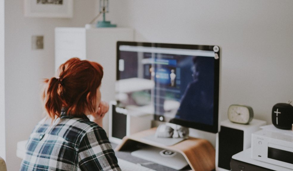 Woman working at home on her Apple Mac computer. Family.