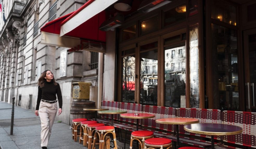 woman walking in front of restaurant in London