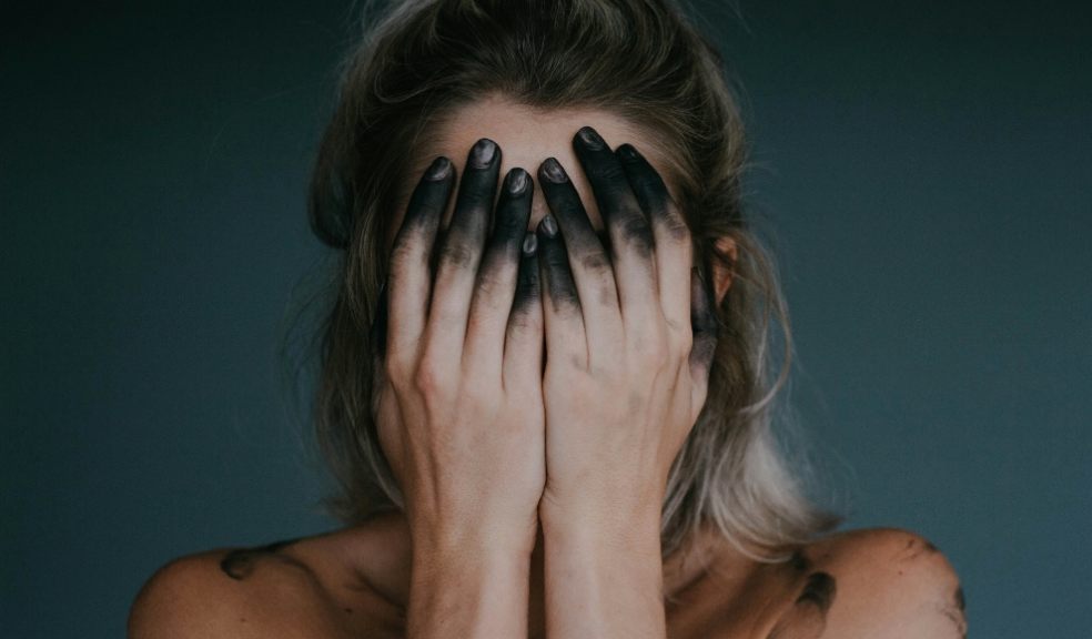 A woman holding her head in her hands
