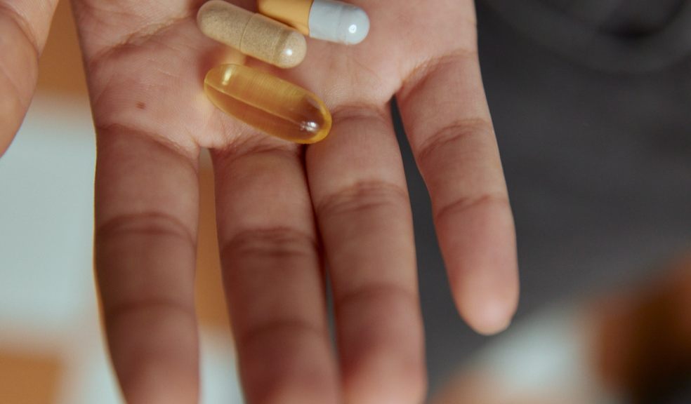 Have you been wondering if you should take vitamins Hand open holding tablets