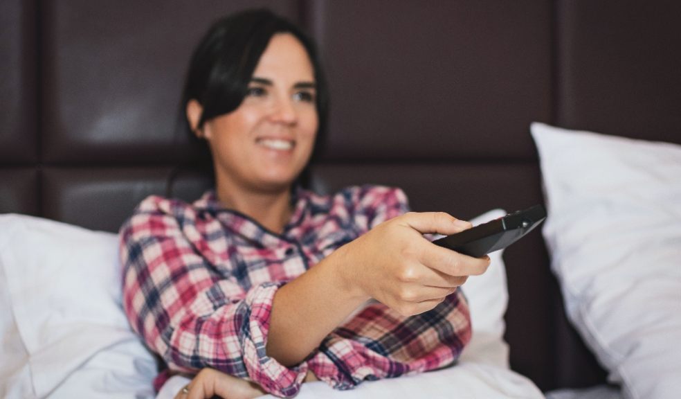 World Cup sleep plan A woman in bed with a remote control