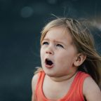 A child with hay fever sneezing