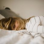 A woman lying awake on a bed
