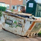 A skip on a driveway