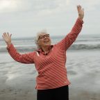 Woman on beach looking happy and free