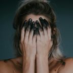 A woman holding her head in her hands