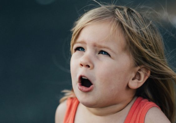 A child with hay fever sneezing