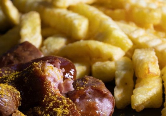 Currywurst and fries A photograph showing currywurst and fries
