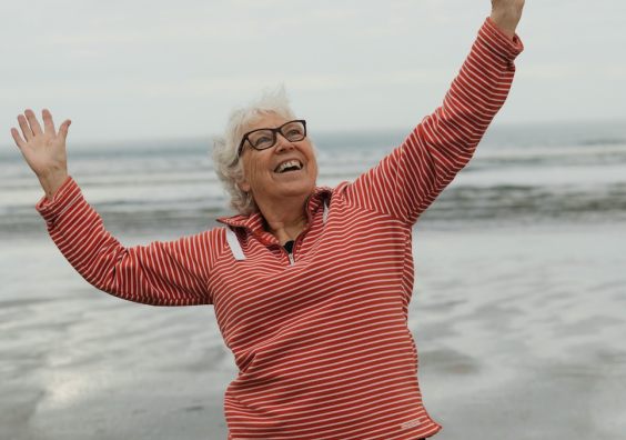 Woman on beach looking happy and free