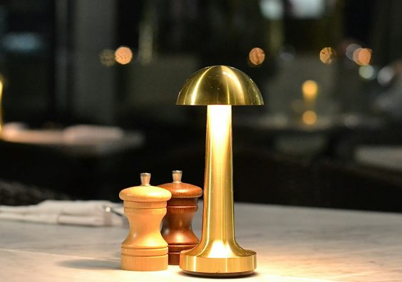 A golden lamp lights up a restaurant table during winter