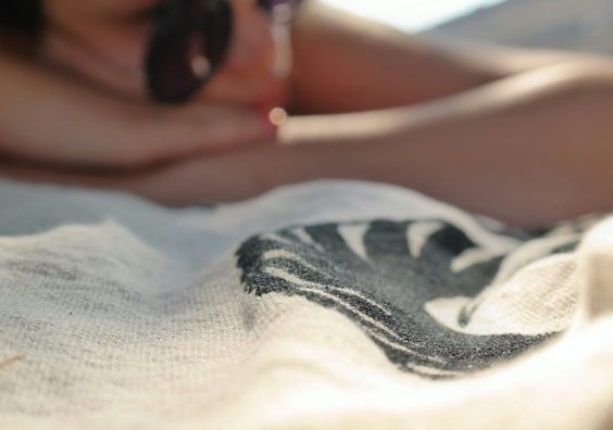 A woman sunbathing win the beach