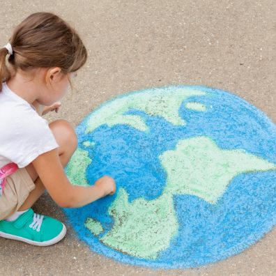 Family. A girl draws a planet of the world with colored chalk on the asphalt. Children’s drawings, paintings and concepts. Education and art, be creative when you return to school. earth, Peace day. jpg  PICTURE: Getty Images/iStockphoto