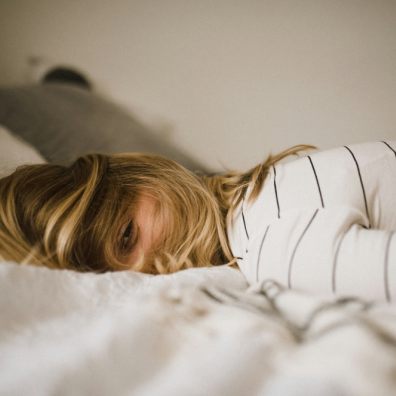 A woman lying awake on a bed