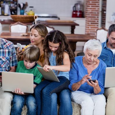 Family on laptops, tablets and mobile phones