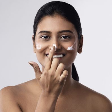 Lady applying sun cream