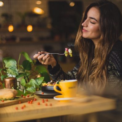 Lady eating at restaurant