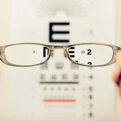 Glasses in front of an eye test chart