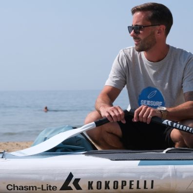 Paddleboarder with his board and oars