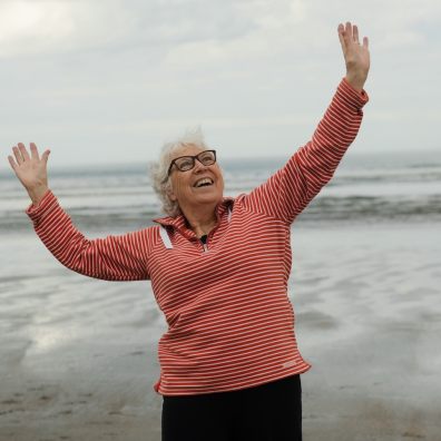 Woman on beach looking happy and free