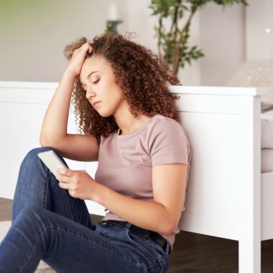 Teenager at home on phone