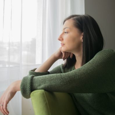 Tenage girl staring out f window. Sad at being alone during Coronavirus. Getty Images/iStockphoto