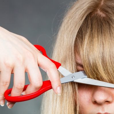 Woman cutting her fringe