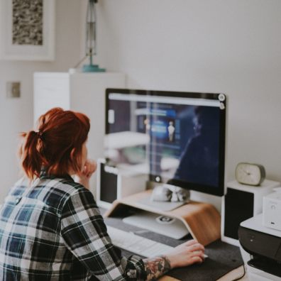 Woman working at home on her Apple Mac computer. Family.