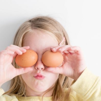 Young girl preparing to cook for her family with eggs.