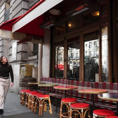 woman walking in front of restaurant in London