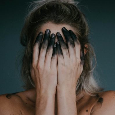 A woman holding her head in her hands