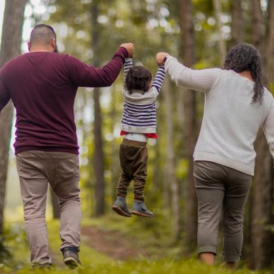 parents out with child  walking