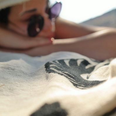 A woman sunbathing win the beach