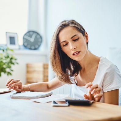 woman with money worries reviewing finances