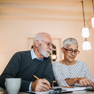 elderly couple checking their home finances